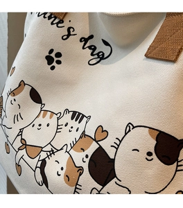 Close-up of canvas texture and cute cat illustration on a large capacity tote bag