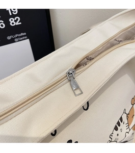 Detailed macro view of the smooth metal zipper and wavy pattern lining of canvas tote bag