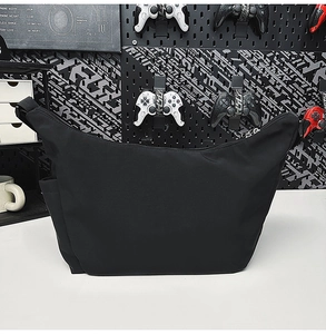 Detail of water-resistant black nylon crescent bag with adjustable shoulder strap
