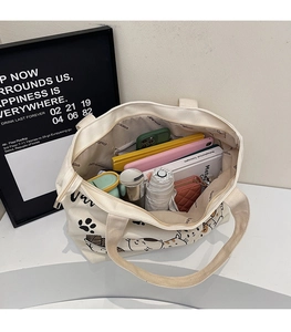 Spacious tote bag interior showing capacity for notebooks, umbrella, and accessories