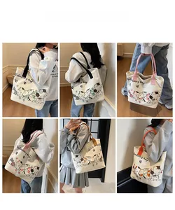 Detailed views of women's canvas tote bag featuring cute cartoon cats and colorful handles