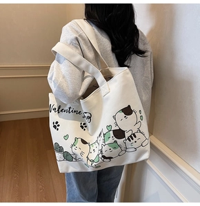 Detail view of the large capacity canvas tote bag with cute cartoon cat patterns