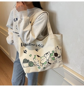Close-up of white canvas tote bag with cute cat illustrations and Valentine's Day print