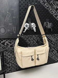 Beige waterproof nylon messenger bag with front zip pockets on black industrial background