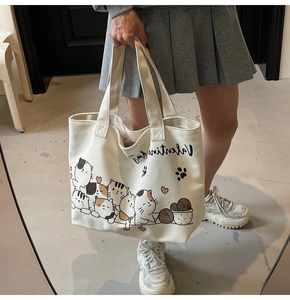 Detail of white canvas tote bag with cute cartoon cats and Valentine's Day print