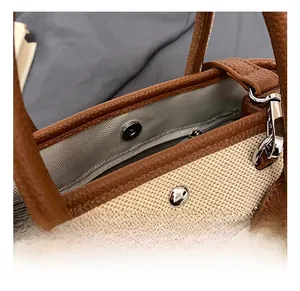 Detail of canvas tote bag showing magnetic snap closure and metal zipper pocket interior