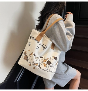 Detail of canvas tote bag showing colorful cartoon cats and Valentine's day print