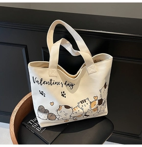 Detailed view of canvas tote bag featuring a cute cartoon cat and Valentine's Day print