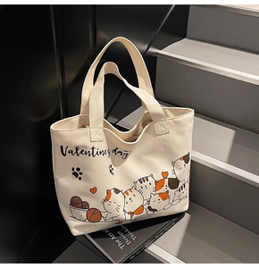 Detail of canvas tote bag featuring cute cartoon cats and Valentine's Day text print
