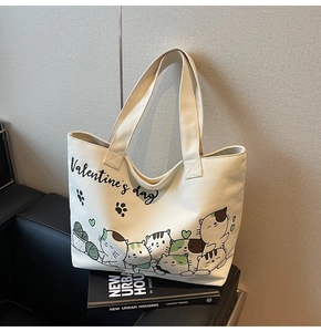 Detail of canvas tote bag with cartoon cat illustrations and Valentine's day print