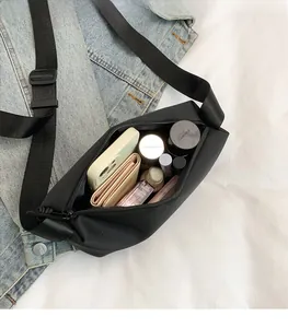 Détail de l'intérieur d'un sac en nylon noir montrant sa grande capacité de rangement