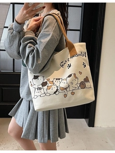 Large cream canvas tote bag with brown handles featuring cute cat prints for daily commute