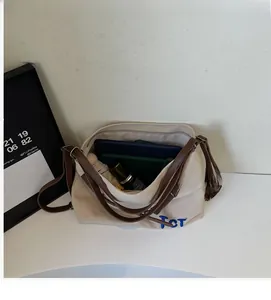 Top-down view of a spacious canvas tote bag showing interior storage and leather straps