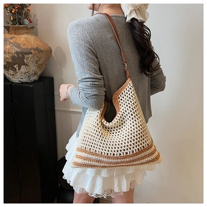 Bohemian crochet knit tote bag with caramel stripes and leather strap on model