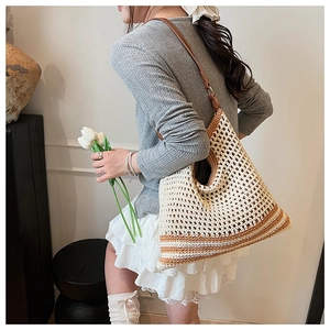 Detailed knit texture and brown leather strap of this hollow crochet beach tote bag
