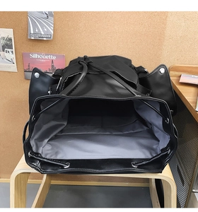 Internal view of large capacity vintage backpack showing compartments and grey lining