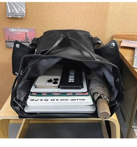 Detailed interior view of a large black travel backpack holding a laptop and essentials