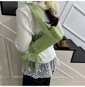 Detail of green Boston pillow bag featuring decorative oversized bow and silver hardware