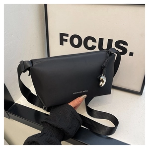 Détail du sac à bandoulière noir avec large sangle et tirette de zip en cœur argenté