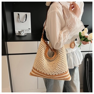 Detail of hollow hand-woven shoulder bag with contrasting mesh and leather strap