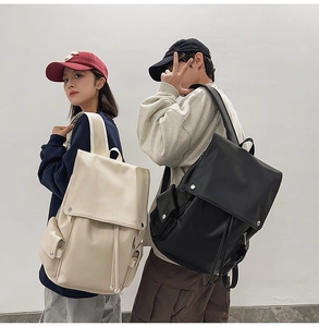 Detail of PU leather backpacks in black and white with large capacity and drawstring