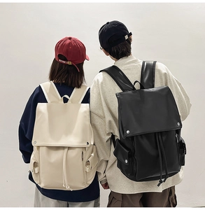 Rear view of black and beige faux leather backpacks with multiple cargo pockets and drawstrings