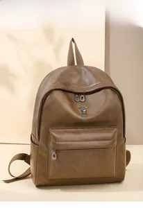 Detailed side view of brown faux leather backpack featuring a rabbit metal ornament