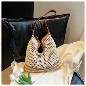 Detailed macro view of the woven saddle bag texture with brown leather strap and zip closure