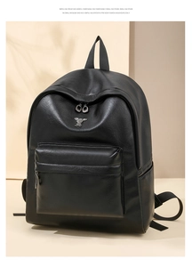 Close-up of black PU leather backpack featuring a stylish metal rabbit charm and texture