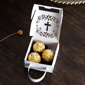 Detailed laser-cut cross hollow gift box holding three pieces of premium chocolate