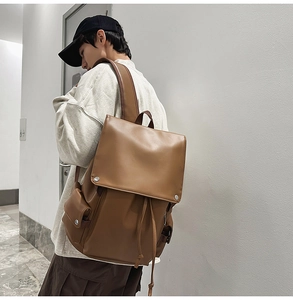 Side view of a brown vintage faux leather backpack on a model for daily commuting