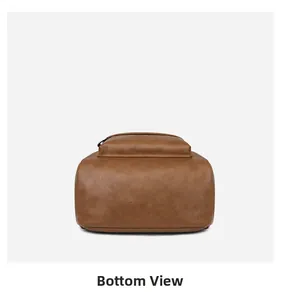 Detail view showing the flat rectangular bottom of the brown pebbled leather backpack