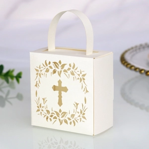 Detail of laser-cut cross and wreath pattern on elegant white wedding gift box