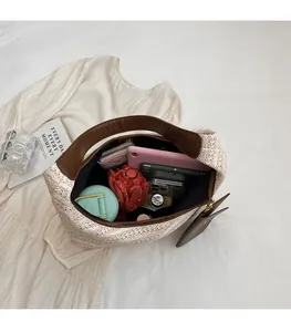 Top view of woven straw tote showing large interior capacity for umbrella and accessories