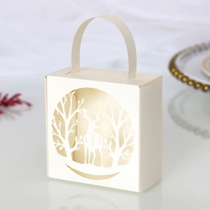 Detail of laser-cut reindeer and white forest patterns on holiday gift boxes