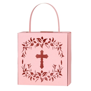 Detail of pink laser-cut candy box featuring hollow cross and floral pattern