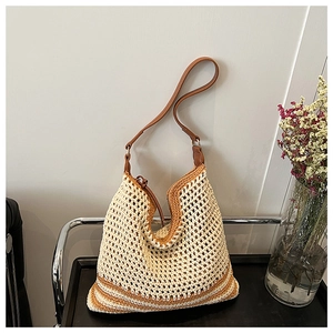Detail of hollow-out woven tote bag featuring beige crochet texture and brown leather strap