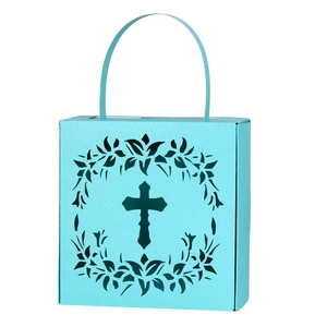 Close-up of light blue laser-cut candy box with hollow cross and floral pattern details