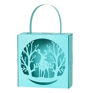 Laser-cut Christmas reindeer candy gift box in light blue with white tree silhouettes