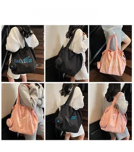 Detailed views of a large canvas tote bag with matching mini pouch and stylish wave logo