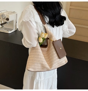 Detail of beige woven tote bag with brown leather strap and matching small card pouch
