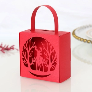Detail of red laser-cut Christmas reindeer gift box with elegant cutout patterns