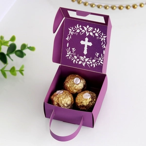 Detail view of purple laser-cut gift box with hollow cross design and handle