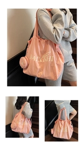 Detail of pink drawstring tote bag with mini coin purse and branded logo print