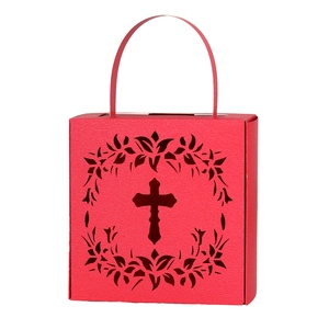 Macro shot of red hollow-out paper candy box featuring cross and floral wreath pattern