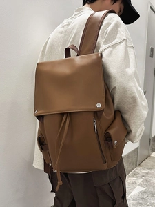 Vintage brown leather backpack with metal buckles and drawstring closure for travel