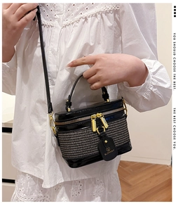 Detail of BLONMAY box bag featuring black leather, woven texture, and gold zippers