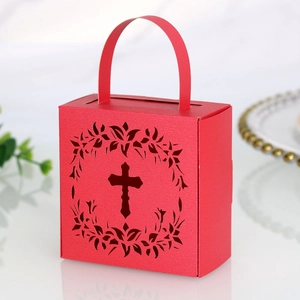 Detail of red laser-cut candy box featuring hollow cross design and sturdy top handle