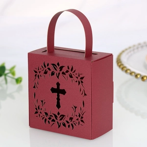 Detailed view of dark red wedding candy box featuring hollow cross and floral pattern