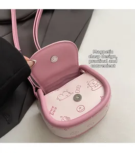 Detail of pink saddle bag featuring a magnetic snap closure and cute cartoon bear lining
